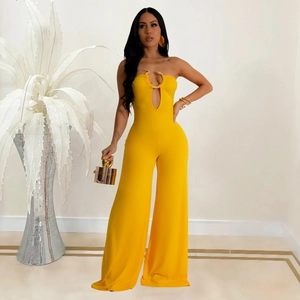 Detail of yellow bandeau jumpsuit featuring a gold snake hardware and waist cutout