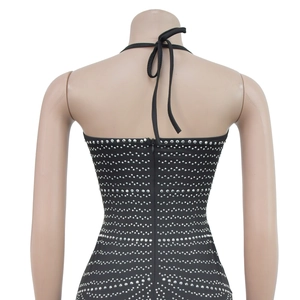 Detail of black halter backless dress with silver rhinestones and a back zipper closure