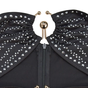 Detail of black rhinestone dress showing the golden sphere buckle and KCC zipper