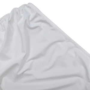 Detailed stitching on white fabric showing fine texture and sleek seam of the dress