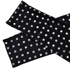 Detail view of black mesh sleeve set featuring sparkling square rhinestone embellishments