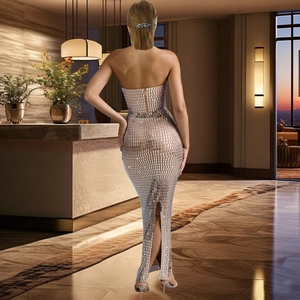 Detailed back view of silver sequin mesh dress with invisible zipper and split hemline