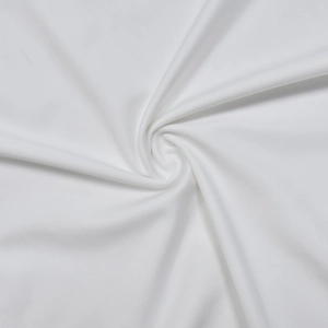 Macro shot of pure white knitted fabric with fine texture and smooth elastic drape