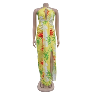 Detail of yellow halter neck maxi dress featuring vibrant tropical palm leaf prints