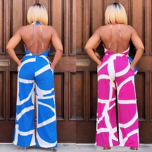 Detail view of halter neck jumpsuits featuring vibrant abstract prints and wide-leg design