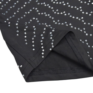 Detail of black dress hem with silver rhinestone wave pattern and neat stitching