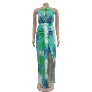 Detail of bohemian halter dress featuring tropical leaf print and front teardrop cutout