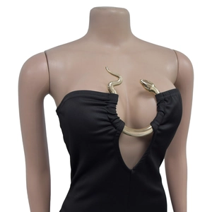 Detail of a black tube top jumpsuit featuring a gold snake-shaped metal V-neck connector