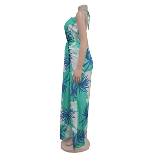 Detail of tropical palm leaf print and backless tie design on summer maxi dress