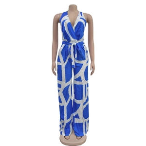 Detailed view of sleeveless V-neck jumpsuit with blue geometric patterns and waist tie