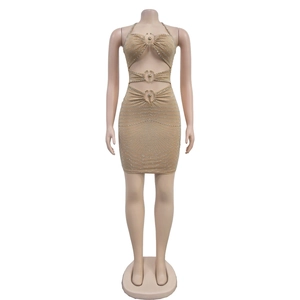 Detail of beige rhinestone mini dress with cut-outs and metal ring connections
