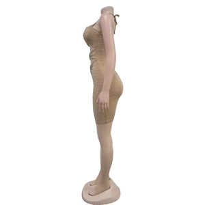 Close-up of nude bodycon dress with silver rhinestones and side cut-out details