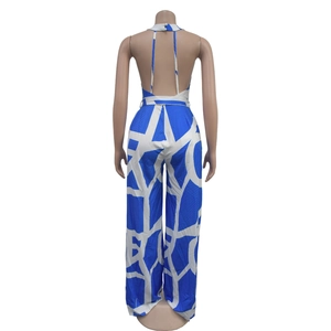 Detail view of the halter back design with button closure on blue geometric jumpsuit