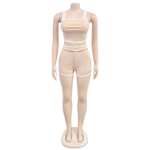 Detail view of seamless nude ribbed yoga set with contrasting white trim and thin straps
