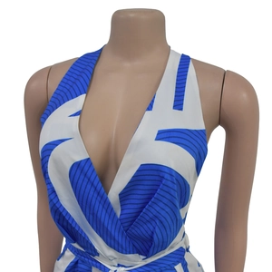 Detail of blue and white wavy print on the sleeveless V-neck halter jumpsuit fabric