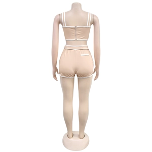 Rear view of beige two-piece lounge set with white piping and back zipper detail