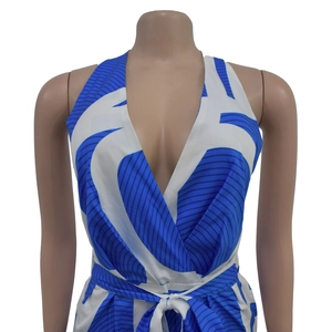 Detail of blue and white abstract print on a halter deep V-neck jumpsuit with waist tie