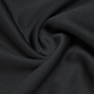 Detailed close-up of premium black knitted fabric showing fine texture and soft drape