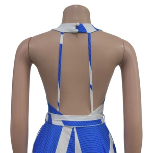 Detail of backless halter jumpsuit featuring blue and white geometric print and neck buttons