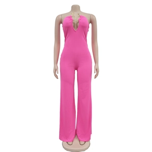 Detail of rose pink halter neck jumpsuit featuring gold metal ring and keyhole cutout