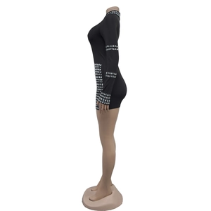 Detail view of silver rhinestones on a black high-neck long-sleeve bodycon mini dress