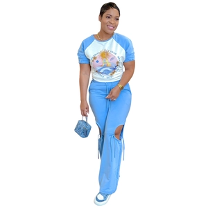 Detail of sky blue raglan sleeve top with retro sun print and knee cutout pants set