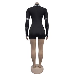 Detailed back view of a slim black long-sleeve romper with sparkling rhinestone collar