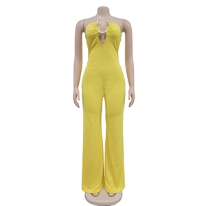 Detail of yellow halter jumpsuit with metallic snake ornament and wide leg cut
