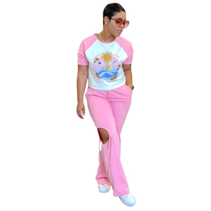 Detail of pink two-piece set featuring retro sun print and knee cutout design for women