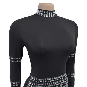 Close-up of sparkling multi-shape rhinestones on black high-neck stretchy slim bodysuit