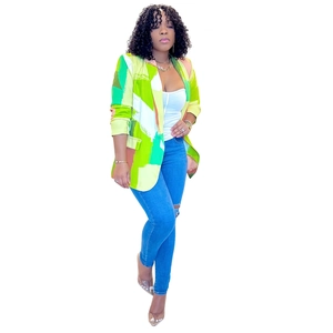 Detailed view of women's long sleeve blazer featuring vibrant yellow and green geometric prints