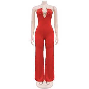 Detail of red tube jumpsuit featuring a cutout chest with a gold snake ring buckle
