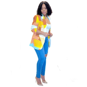 Detail shot of modern floral blazer with abstract pattern and vibrant geometric color blocks