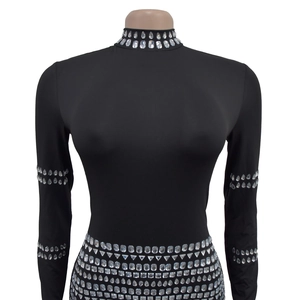 Detail of black rhinestone bodysuit with high neck and intricate geometric crystals