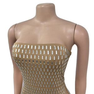 Detail of khaki bodycon dress featuring rows of silver rectangular mirror sequins decor