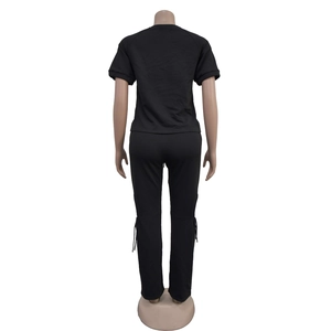 Back view of a casual black two-piece set with short sleeve top and drawstring joggers