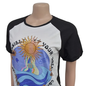 Detail of a black and white raglan sleeve T-shirt with sun and waves print graphic