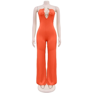 Detail of a bright orange tube jumpsuit featuring a metallic snake ring at the neckline