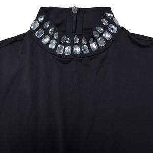 Close-up of black turtleneck neckline featuring luxury crystal rhinestones and back zipper