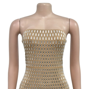 Detail of nude bodycon dress featuring vertical rows of shimmering silver sequins