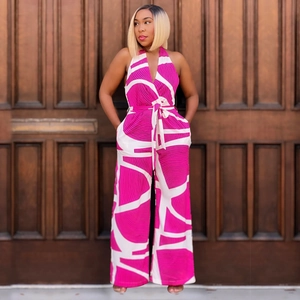 Detail of pink and white geometric print sleeveless V-neck wide leg jumpsuit with waist tie