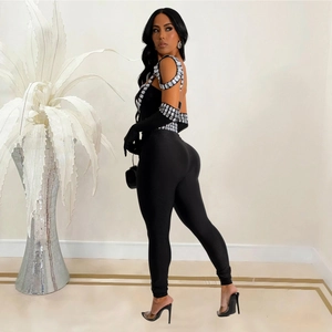 Elegant black backless jumpsuit featuring oversized luxury rhinestones and matching gloves