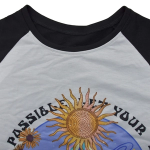 Detail of soft cotton t-shirt featuring retro sunflower and planet graphic print