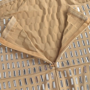 Detail of camel sleeveless dress featuring rectangular rhinestones and invisible zipper