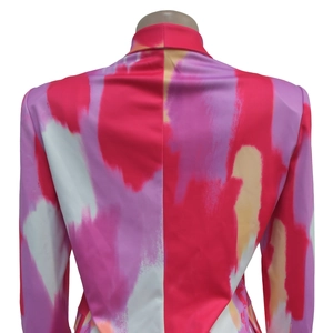 Detailed back view of women's blazer featuring abstract red and pink artistic prints