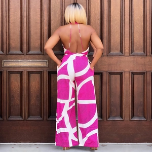 Detail of backless jumpsuit with pink geometric prints and wide-leg cut on a model