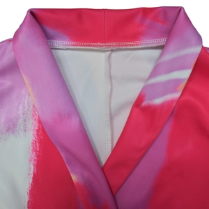 Close-up of pink marble print notch lapel and fine stitching on a woman blazer