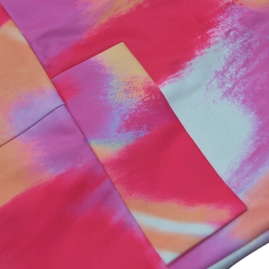 Close-up of abstract pink and orange floral print fabric with durable double-stitch seams