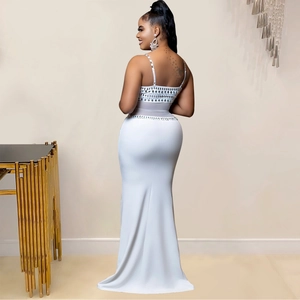 Close-up of white sequin backless evening gown with silver rhinestone embellishments