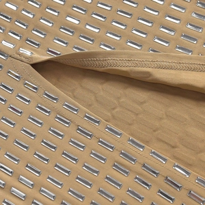 Detailed macro view of khaki fabric featuring sparkling rectangular rhinestones on the surface